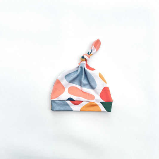 Knotted baby hat in abstract print unisex colour